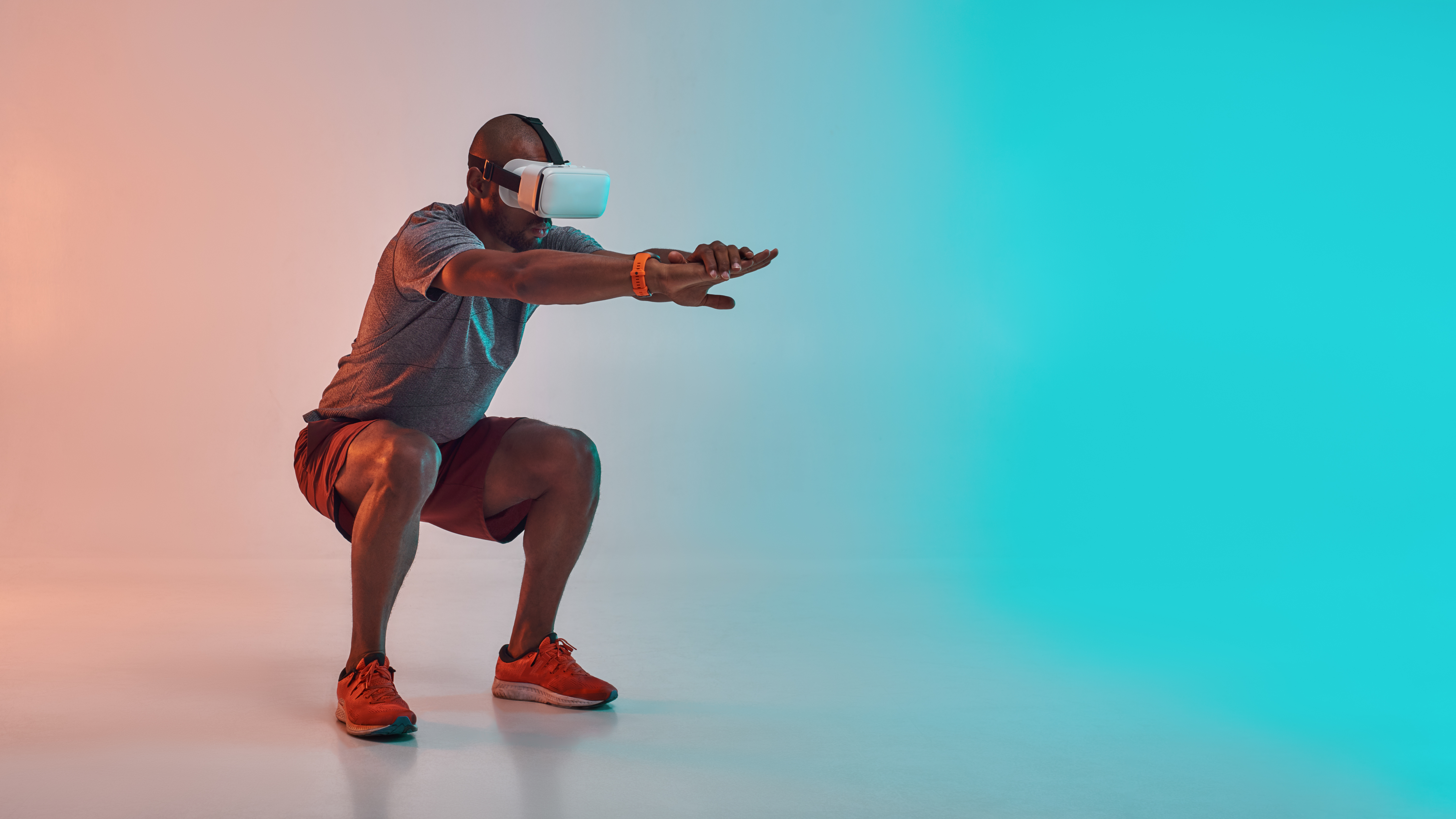 A man in a VR headset, squatting and holding his arms out in a workout pose.